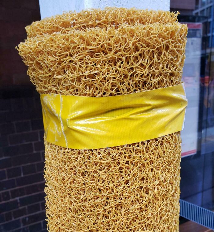 Close-up of a large bundle of instant noodles tied with yellow tape, a common forbidden food to avoid eating.