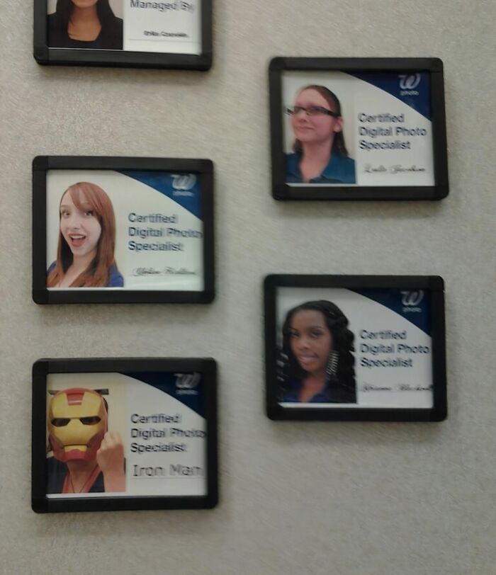Employee name badges on a wall including a prank with an Iron Man mask, showing employees with jokes and pranks at work.