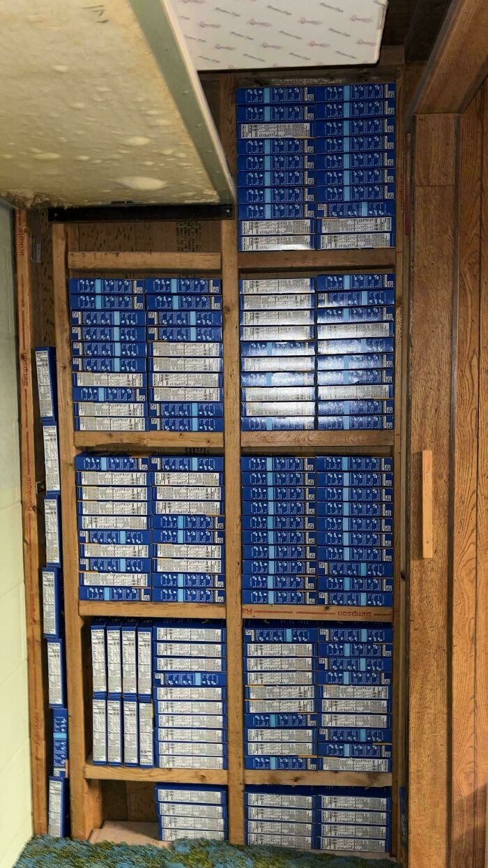 Neatly aligned boxes stacked perfectly inside a floor compartment, showcasing things aligned so perfectly.