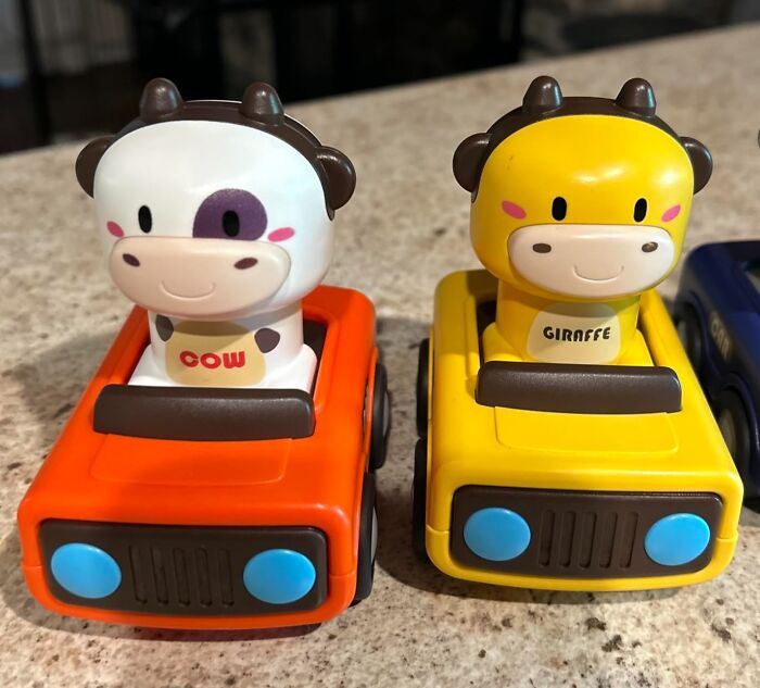 Two colorful kids toys featuring a cow and giraffe driving small vehicles, highlighting Black Friday week deals on kids toys.