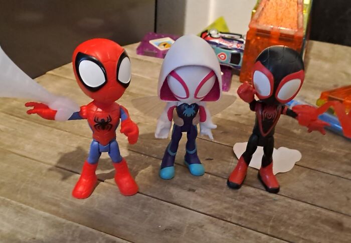 Three Spider-Man themed kids toys displayed on a wooden surface showcasing Black Friday week deals on kids toys.