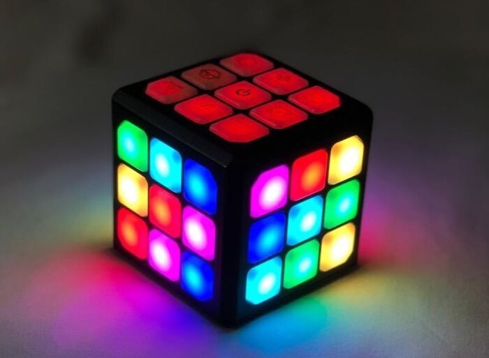 Colorful illuminated puzzle cube toy glowing in a dark room, showcasing kids toys Black Friday week deals for Christmas gifting.