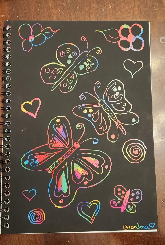 Spiral-bound scratch art notebook with colorful butterfly and heart designs for kids toys creative play.