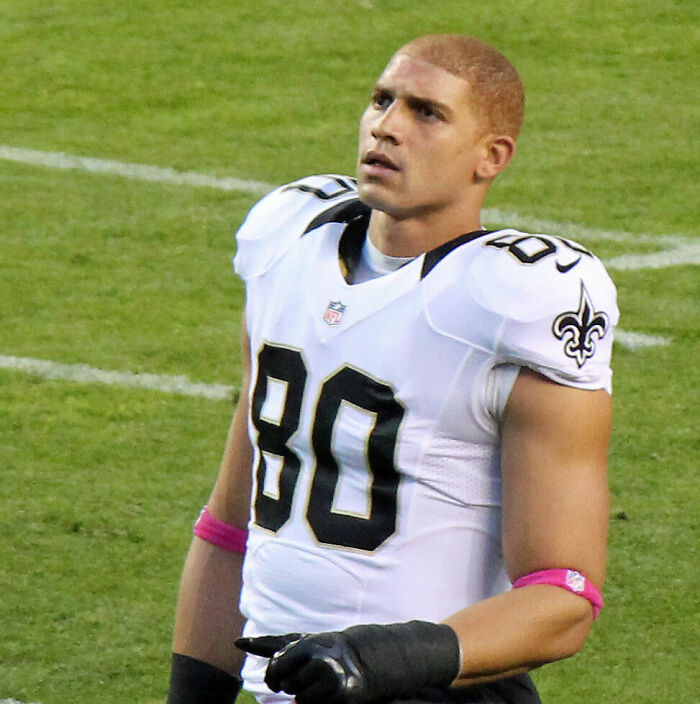 Jimmy Graham in New Orleans Saints uniform on the field during an NFL game, focused and ready to play.