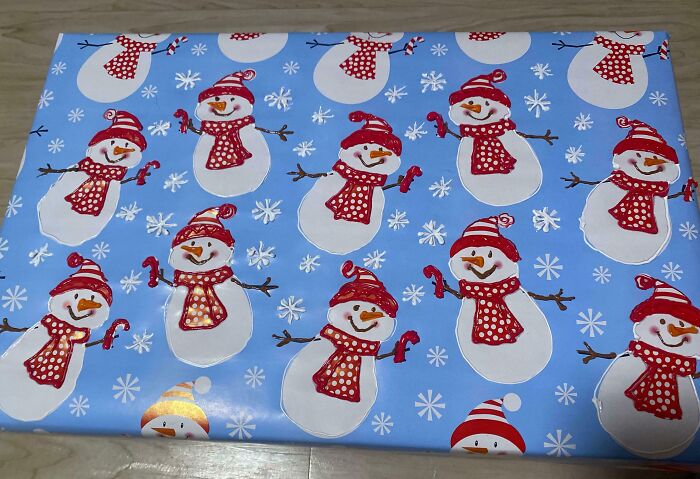 Wrapping paper with cheerful snowmen wearing red scarves and hats, creating a grateful sibling holiday vibe.