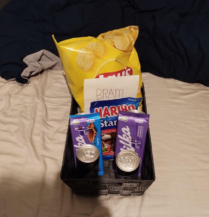Gift basket with snacks and drinks, showing sibling gratitude with a handwritten note inside the basket.