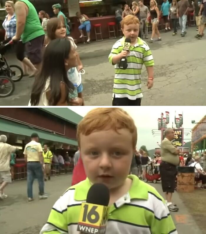 Young boy with red hair wearing a striped shirt holding a microphone at a crowded outdoor event, viral internet icon moment.