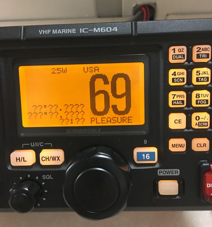 VHF Marine radio display showing channel 69, illustrating men never grow up with playful communication device.