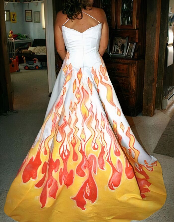 Woman wearing a wedding dress with bold flame design patterns, showcasing questionable taste in wedding dresses.