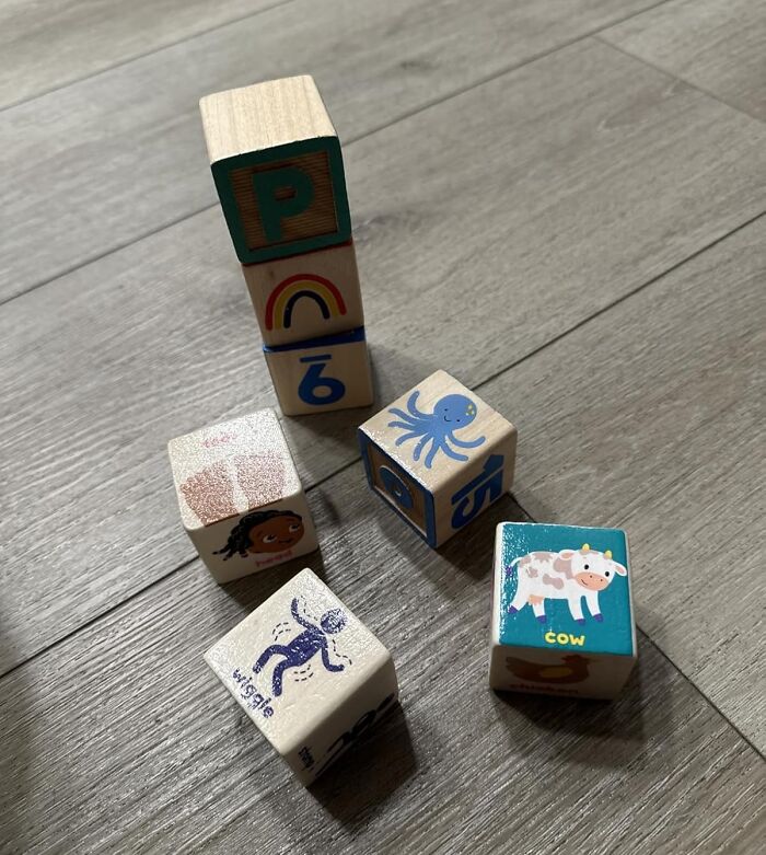 Wooden blocks with colorful letters, numbers, and animal illustrations representing playful learning for Black Friday deals.