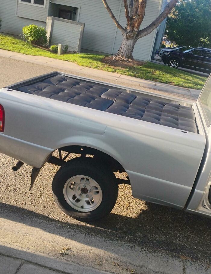 Truck bed lined perfectly with a mattress, showcasing one of the rare times things aligned so perfectly to surprise everyone.