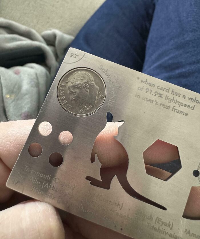 Close-up of a perfectly aligned coin within a metal stencil featuring a kangaroo cutout, showcasing precise alignment details.