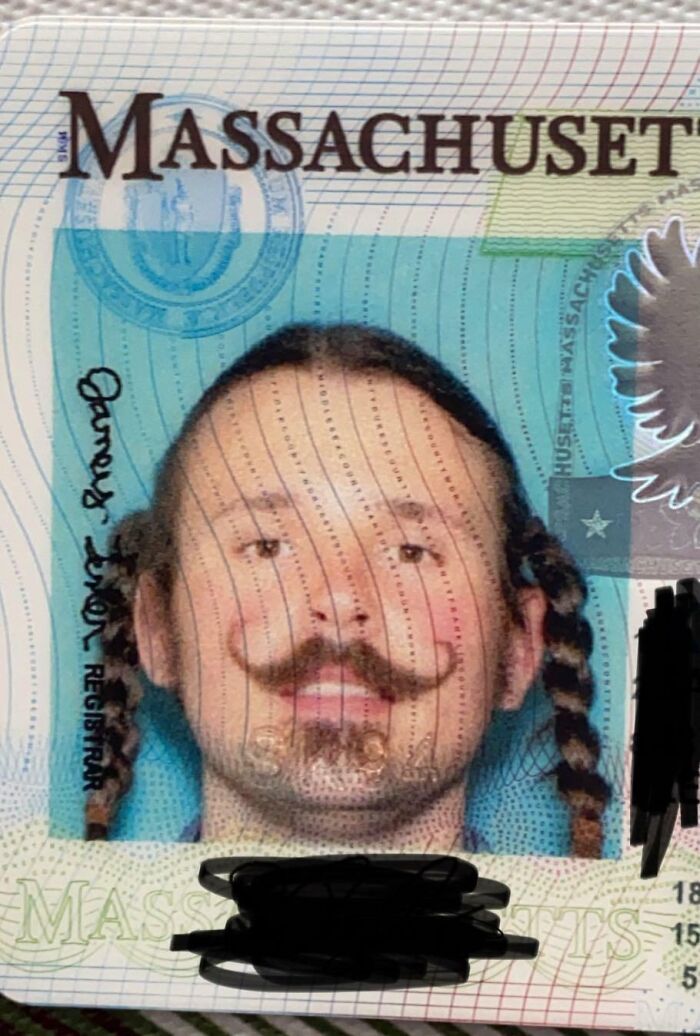 Man with braided hair and twirled mustache on Massachusetts ID photo showing men never grow up concept.