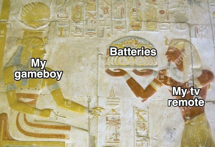 Ancient Egypt meme with hieroglyphics showing batteries powering a gameboy and a TV remote humorously.