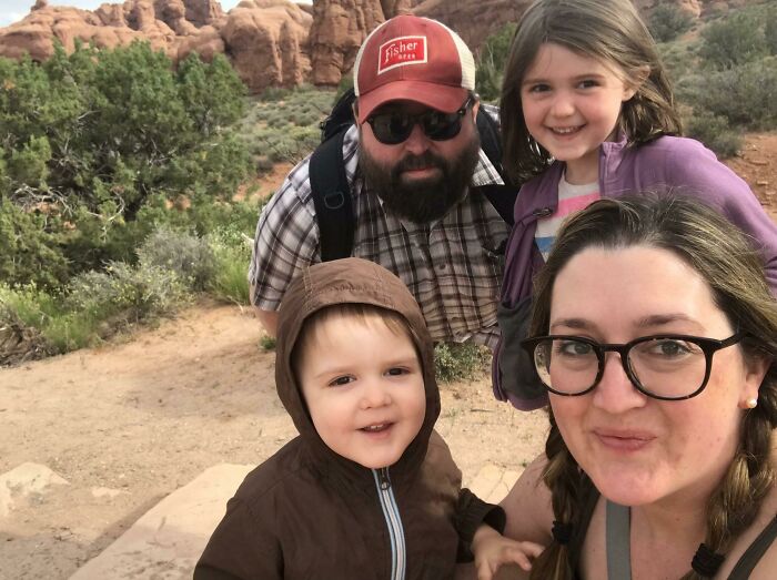 Family hiking outdoors with red rock formations, a photo so confusing your brain might need a moment to catch up