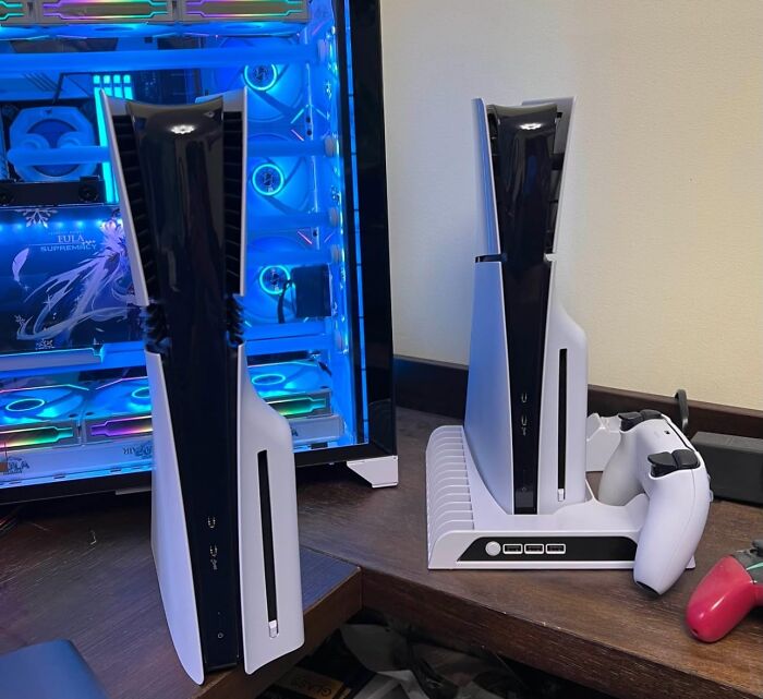 Two PlayStation 5 consoles and controllers on a desk next to a gaming PC with blue LED lighting, highlighting Black Friday deals.