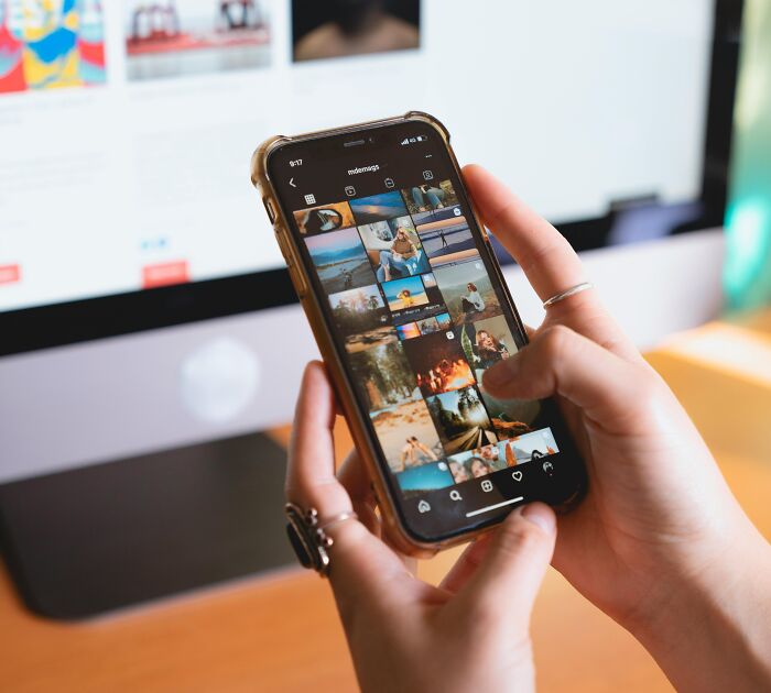 Person scrolling social media on smartphone, a relatable moment showing common digital habits and behaviors.