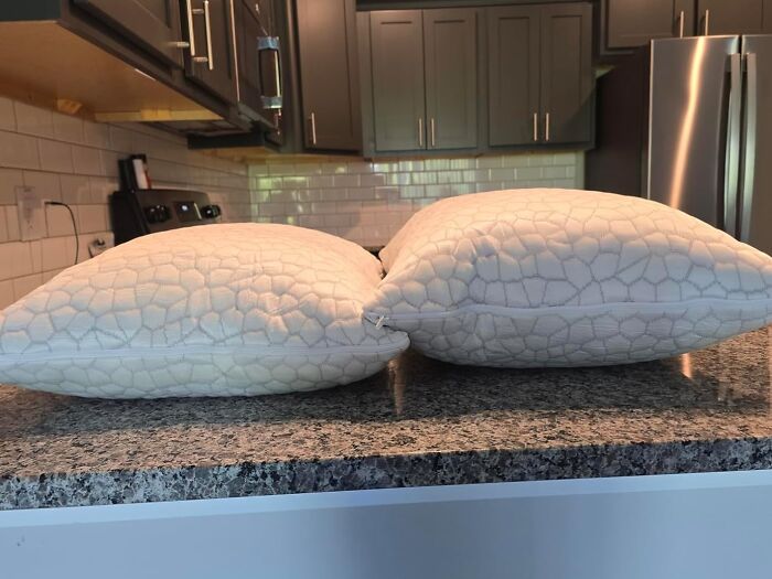 Two white pillows on a kitchen countertop highlighting Cyber Monday deals and biggest steals for the weekend.