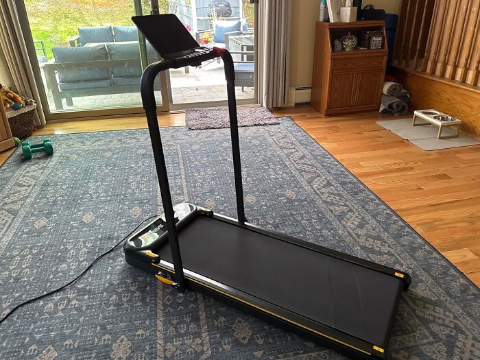 Treadmill with laptop on stand inside a living room highlighting Cyber Monday tech deals available this weekend.