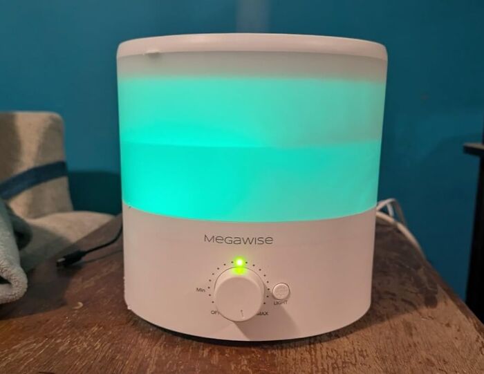 Megawise essential oil diffuser with glowing blue light on wooden surface, highlighting Cyber Monday tech deals.