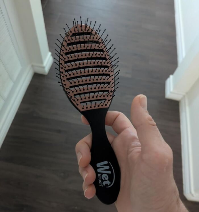 Hand holding a Wet Brush hairbrush, one of the popular Cyber Monday deals trending online this year.