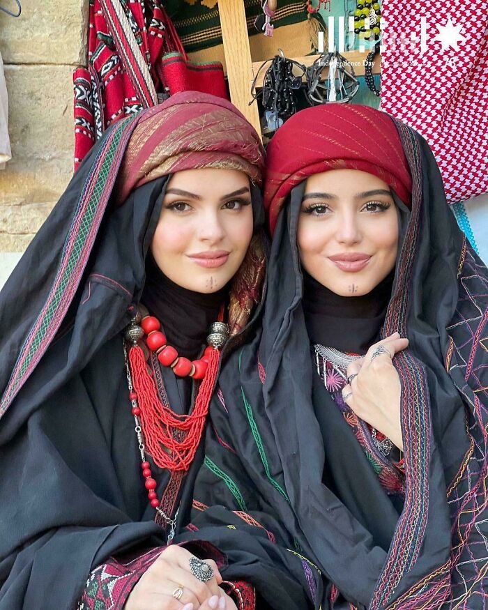 Two women in traditional attire showcase the beauty, strength, and diversity of humans often overlooked.