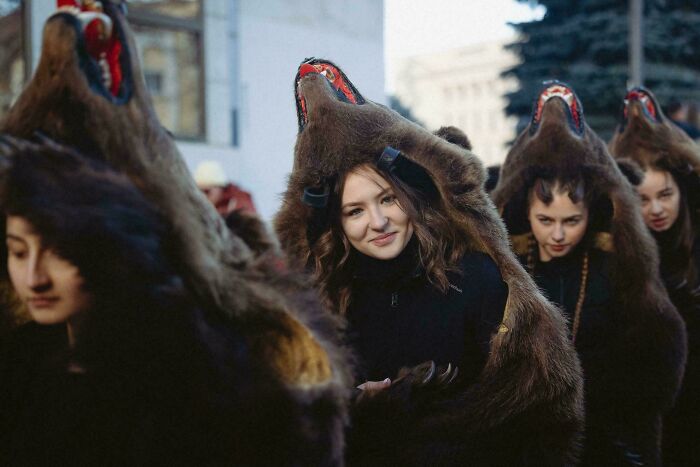 Group of diverse people wearing bear costumes posing outdoors, showcasing strength and beauty in unique cultural portraits.