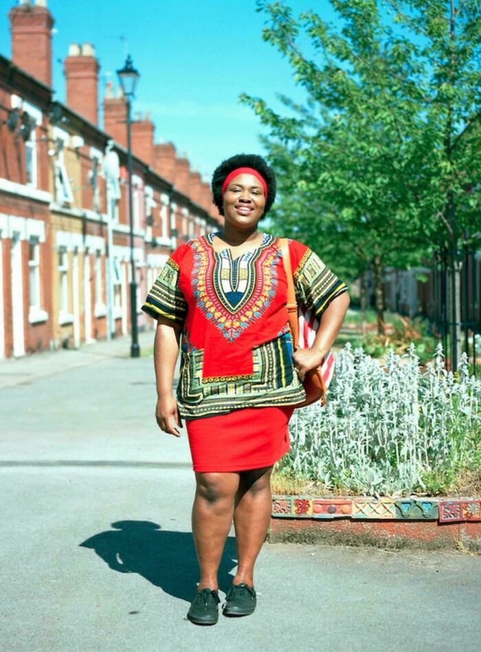 Confident portrait of a smiling woman wearing colorful traditional attire, showcasing the beauty and diversity of humans.