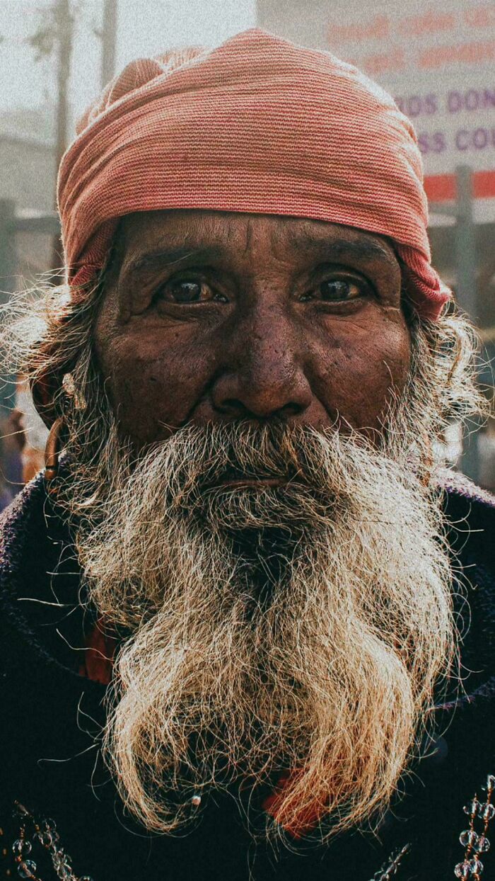 Close-up portrait of an elderly man with a long white beard and headscarf capturing human beauty and diversity.