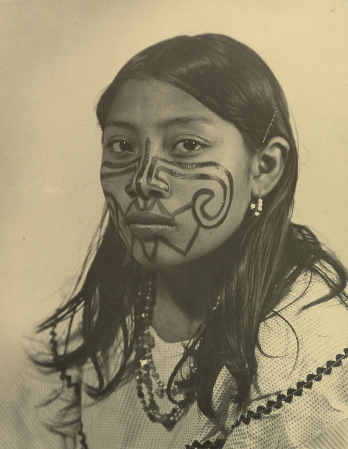 Portrait of a young woman with traditional face paint and jewelry, showcasing the beauty and diversity of humans.