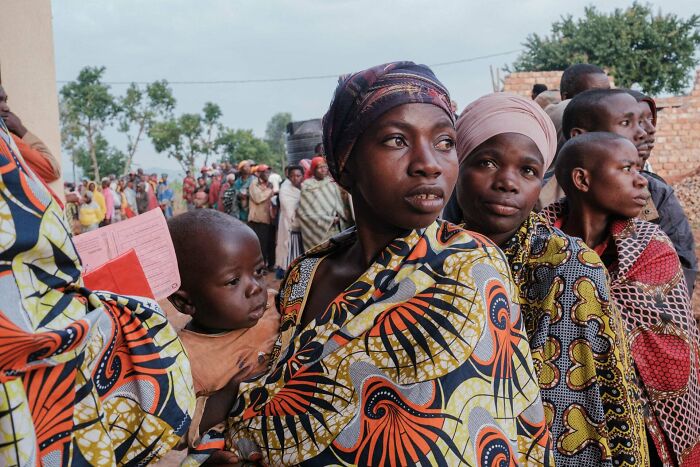 A group of diverse people in colorful clothing standing in line, capturing the beauty and strength of humans often overlooked.