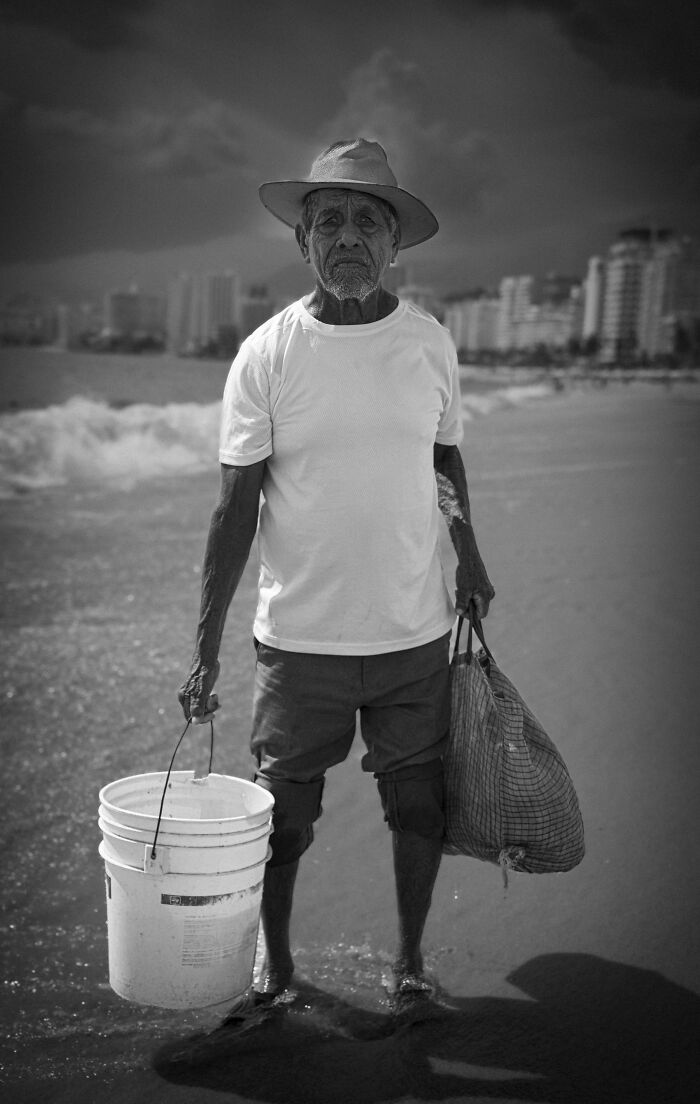 Black and white portrait of an elderly man on the beach capturing the beauty, strength, and diversity of humans.