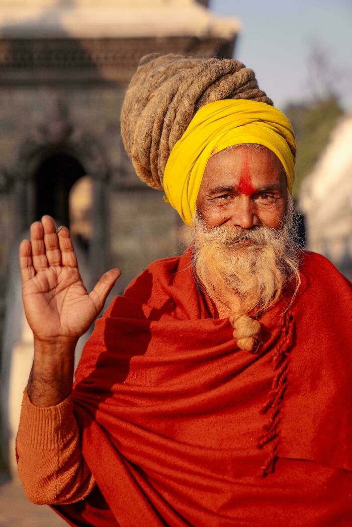 Portrait of an elderly man with a yellow turban and red robe, capturing the beauty, strength, and diversity of humans.