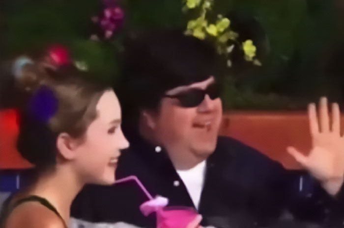 Amanda Bynes smiling outdoors with a drink, breaking silence after claim against Dan Schneider goes viral.