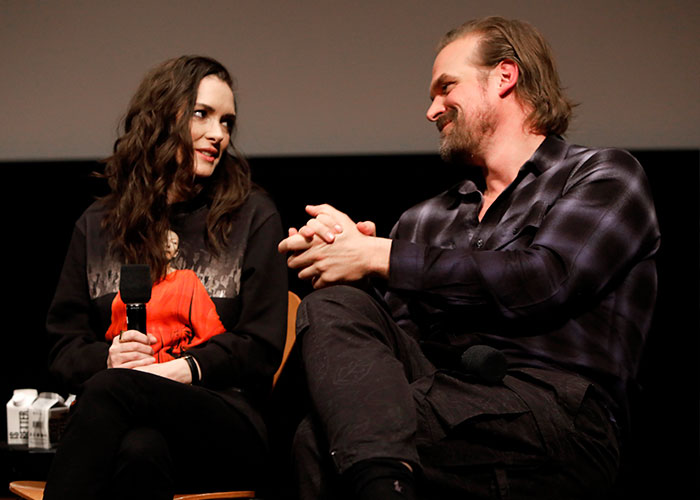 David Harbour and Stranger Things co-star sharing a moment during an interview at a promotional event.