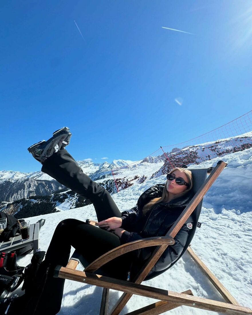 Lily Phillips, adult influencer, relaxing in snowy mountains wearing black outfit and sunglasses under clear blue sky. Lily Phillips, adult influencer, relaxing in snowy mountains wearing black outfit and sunglasses under clear blue sky.