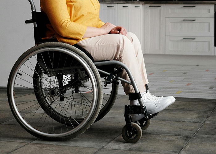 Person in a wheelchair indoors, illustrating common knowledge that often surprises and blows people's minds.