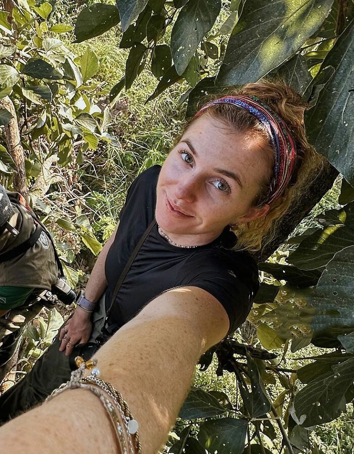 Woman solo traveling in a forested area taking a selfie, revealing the disturbing truth about local man's vile act.