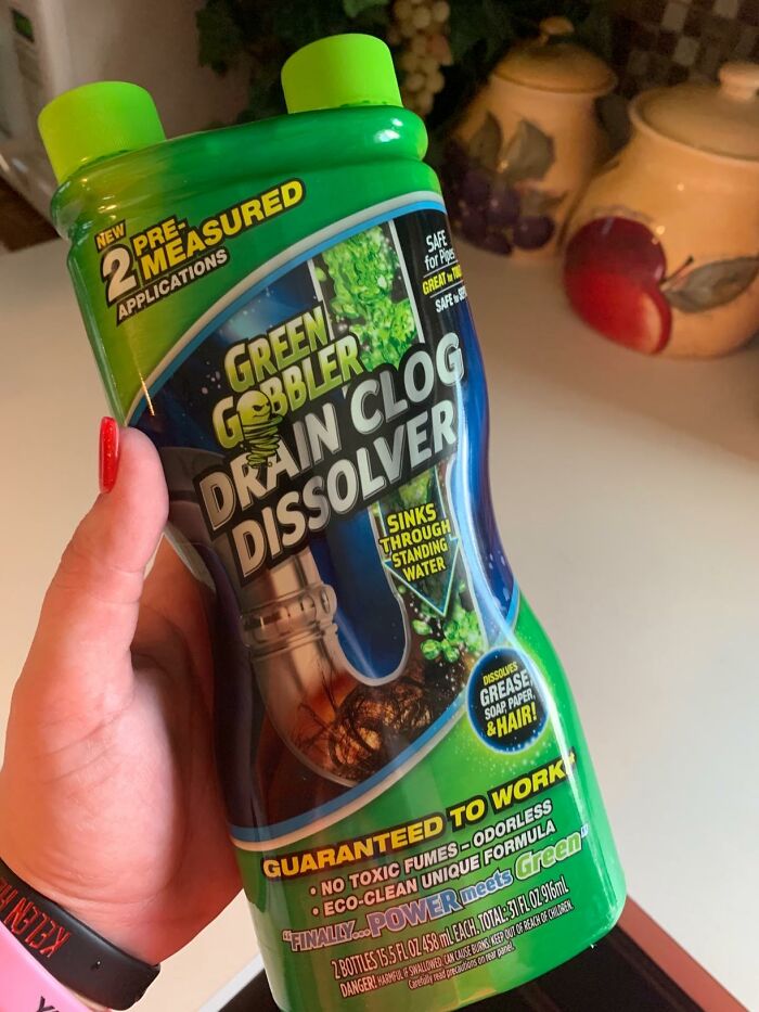 Green Gobbler drain clog dissolver held in hand, a product to help get full security deposit back by fixing plumbing issues.