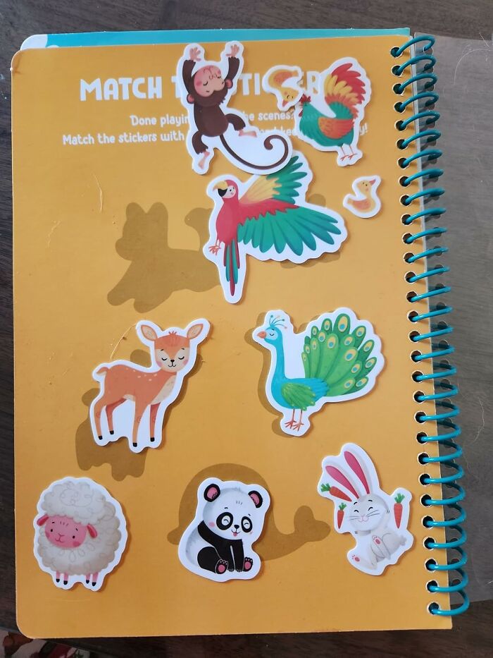 Colorful animal stickers on a yellow activity book, a playful stocking stuffers idea for kids during the holiday season.
