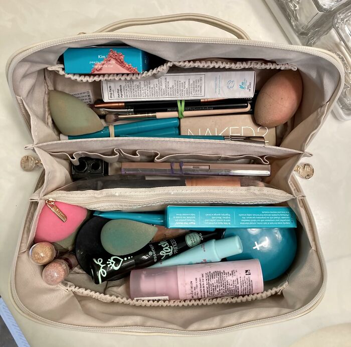 Makeup bag filled with beauty tools and cosmetics, perfect gifts for friends with an aesthetic personality trait.