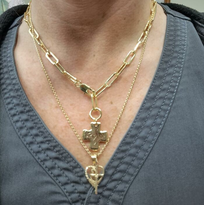 Close-up of layered gold necklaces with cross and heart pendants, featured in Alix Earle’s Amazon Black Friday deals.