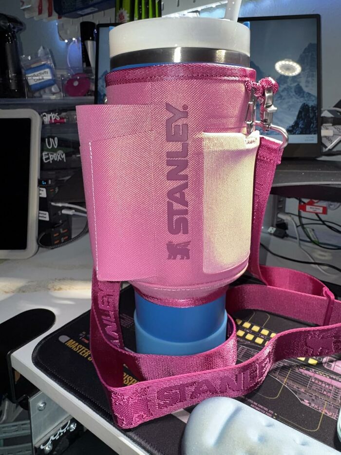 Pink Stanley insulated tumbler with strap on desk showcasing Black Friday deals product.