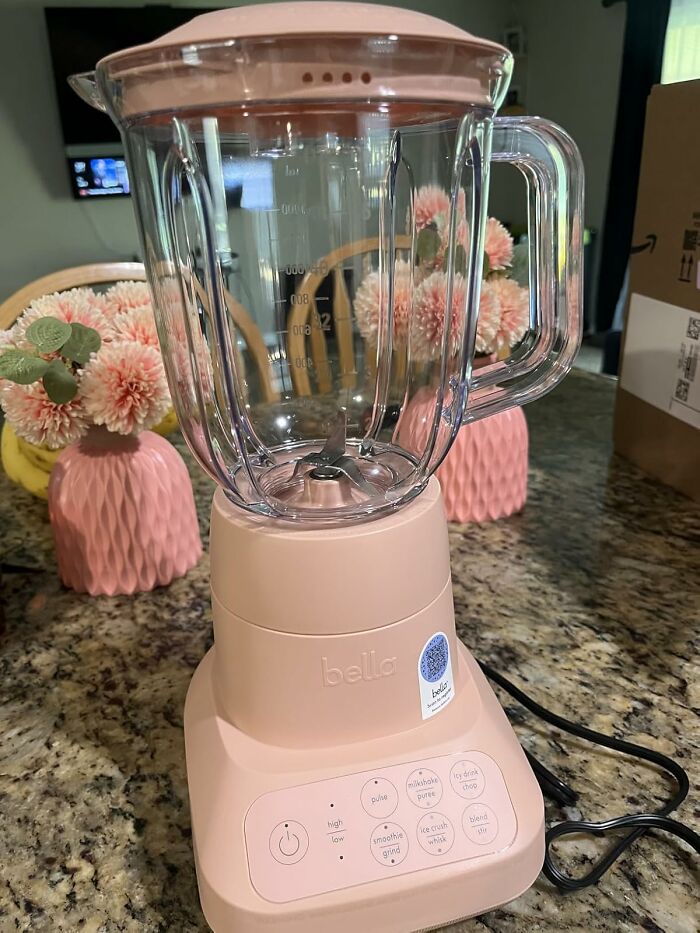Pink Bella blender on kitchen counter with floral decor, highlighting Cyber Monday biggest steals and brand discounts.