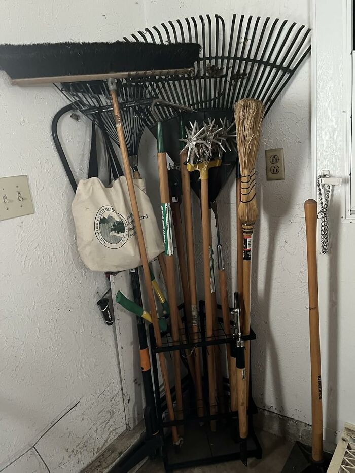 Gardening tools stored in a corner, ready for garden tasks before the first freeze to protect plants and soil.