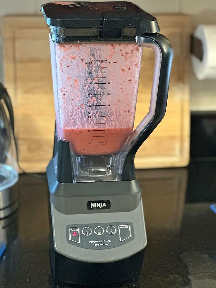 Ninja blender with fresh pink smoothie inside on kitchen counter, highlighting top 11.11 deals for kitchen appliances.