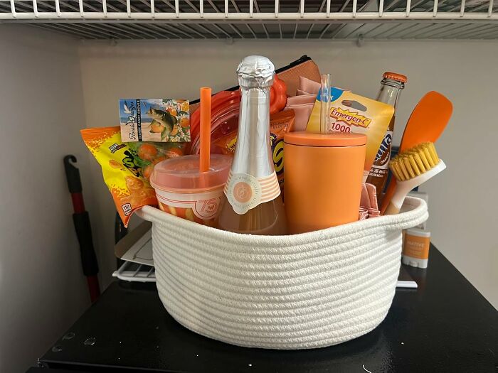 Burr basket starter kit with snacks, drinks, vitamins, and cozy goodies for hibernating until spring in a white rope basket.