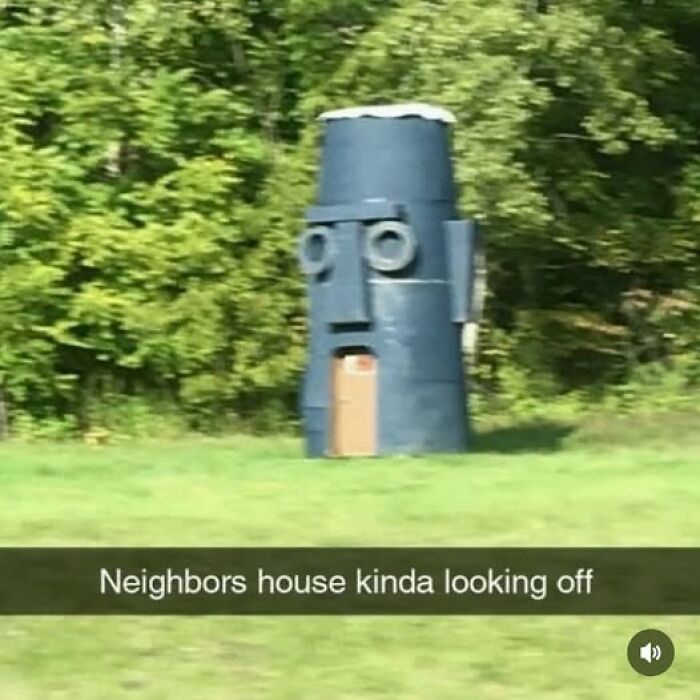 Unusual blue house shaped like a large Moai statue in a grassy area, featured in pics that go hard collection.