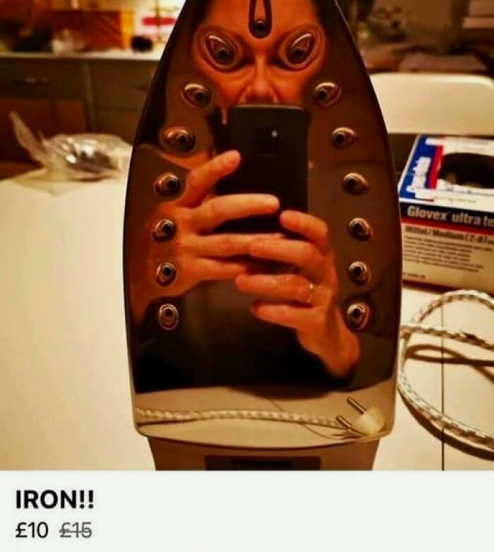 Reflection of a person distorted in a shiny iron surface, creating a surreal and attention-grabbing visual effect.