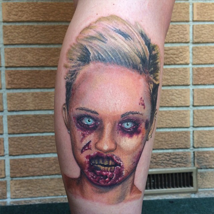 Tattoo artist shares viral tattoo regrets featuring a detailed and eerie portrait tattoo on the leg against brick background.